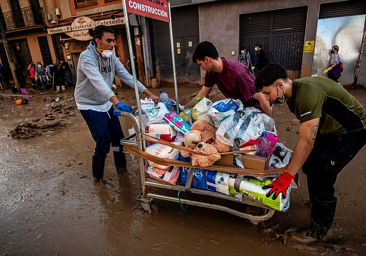 Voluntarios contribuyendo a retirar el barro en La Torre.