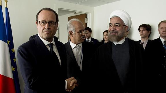 El presidente de Irán, Hasán Rohaní (d, delante), estrecha la mano de su homólogo francés, François Hollande (i, delante)