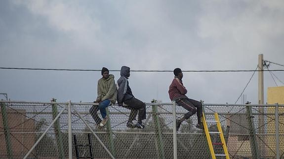 Inmigrantes encaramados a la valla de Melilla. 