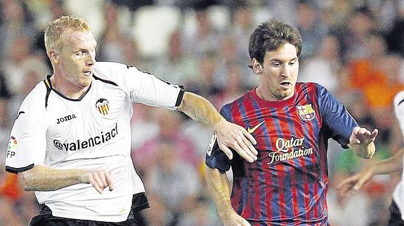 Mathieu disputando un balón con Messi. 