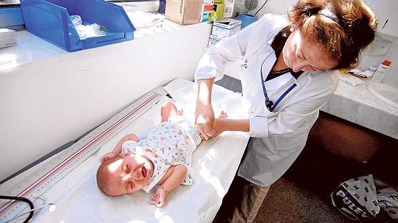Una pediatra vacuna a un niño en el centro de salud de Nazaret, en Valencia.