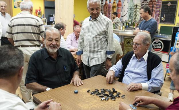 Los empresarios mexicanos Carlos Slim (i) y Olegario Vázquez Raña juegan una partida de dominó en un bar de Avión (Ourense).