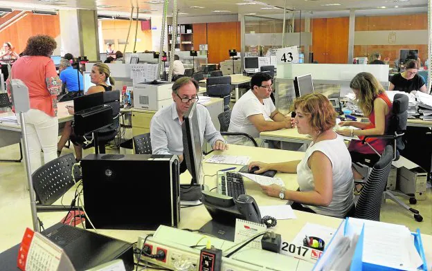 Empleados de la Consejería de Hacienda atienden a varios contribuyentes.