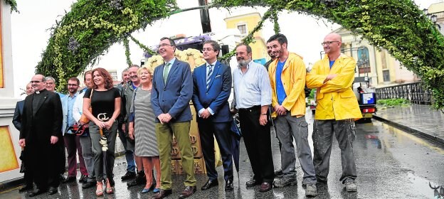 El alcalde, ayer, con la familia propietaria de la Virgen de los Peligros, el deán y el cabo de andas de la Fuensanta, y representantes de cofradías, en el arco floral del Puente Viejo. 