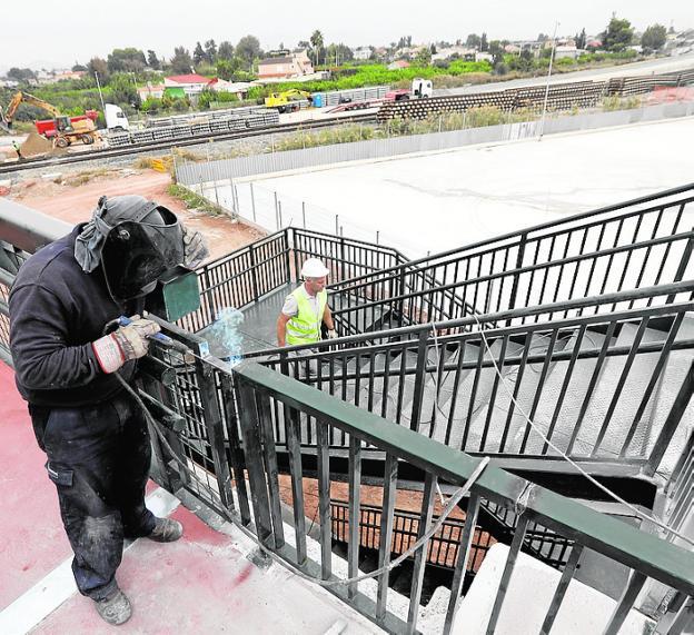 Operarios trabajando ayer en el montaje de la escalera.