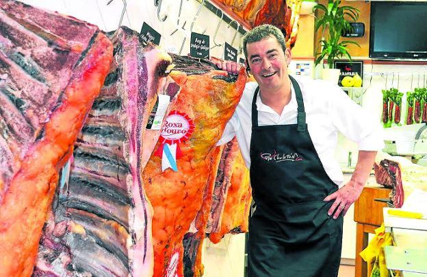 José Luis Sáenz, Pepe 'Chuletón', posa junto a un imponente chuletero en su carnicería de Calahorra, en La Rioja.