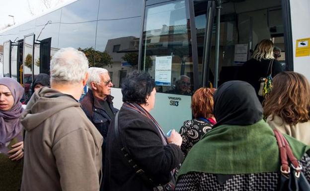 Varias personas cogen el autobús en La Palma. 