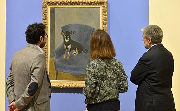 Unos visitantes observan el cuadro de la exposición de la obra de Sofía Morales.