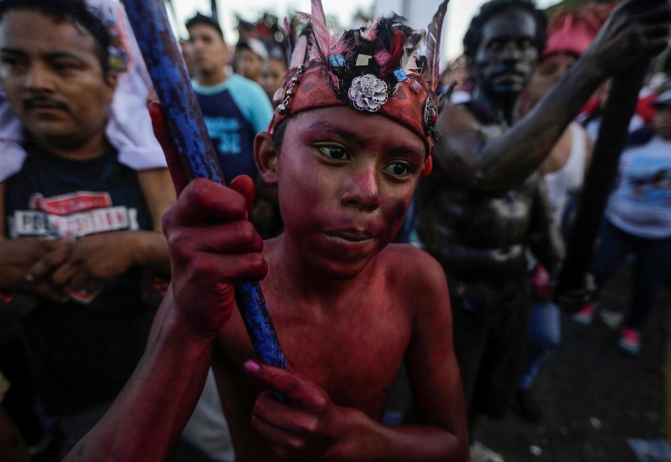 Varias personas llevan el cuerpo cubierto con aceite para cumplir con la tradición de «Los Diablitos Negros» durante una procesión en la que fieles católicos transportan la imagen de Santo Domingo de Guzmán, en Managua (Nicaragua). Como es tradición, la música pone el tono festivo y los creyentes bailan a la vez que avanzan hacia el norte de Managua, alrededor de la imagen, que es zangoloteada por los cargadores, como símbolo de alegría.