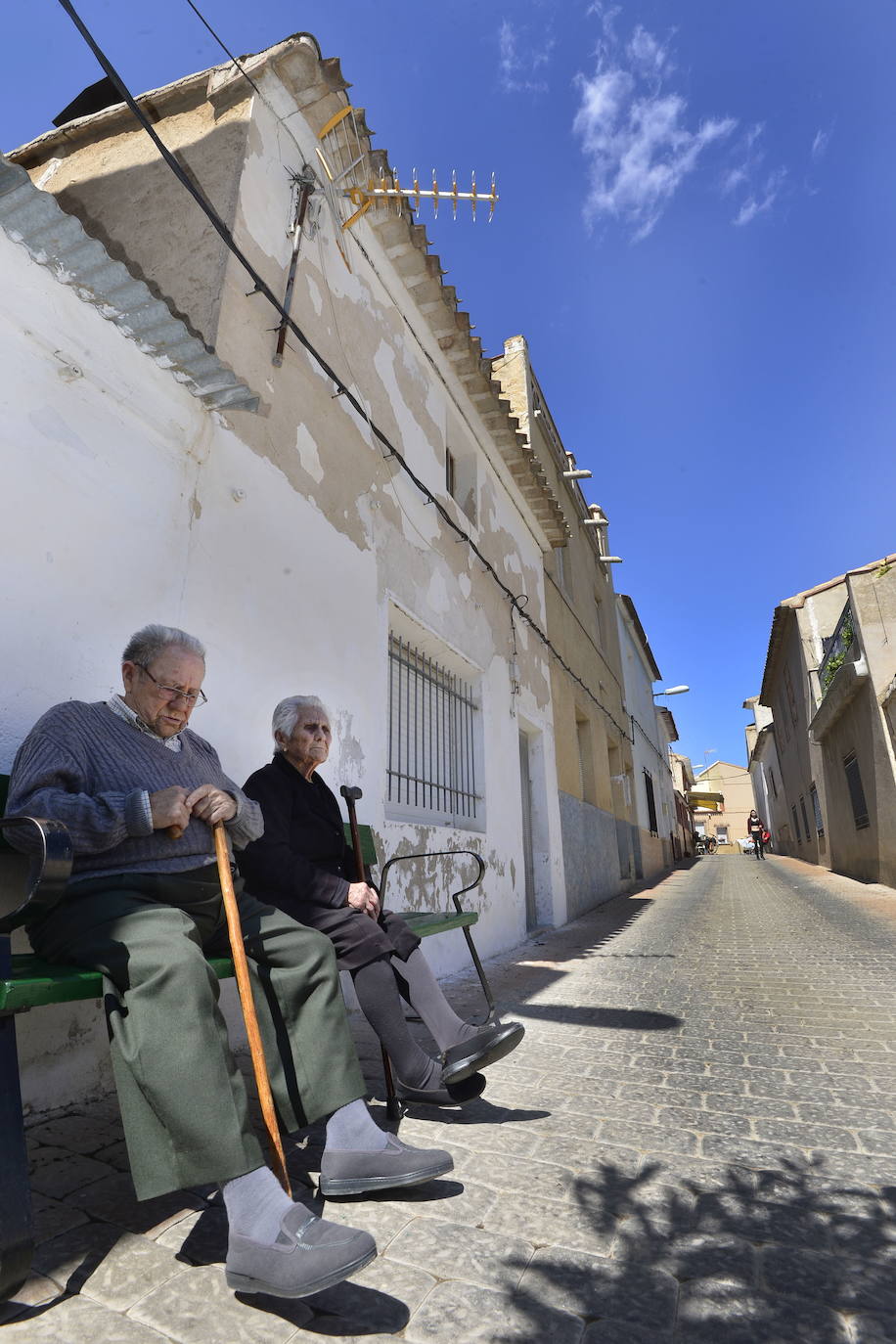 07-04-2019. La Región despoblada. Casi la mitad de los municipios han perdido habitantes en los dos últimos años, y en 35 núcleos viven ya menos de diez personas. Entre 2016 y 2018, un total de 22 municipios han perdido habitantes censados en el padrón. Destacan entre ellos las caídas del 13,3% de Mazarrón, el 5,8% de Los Alcázares o el 2,7% de San Javier. En la imagen, dos ancianos dejan pasar el tiempo en Casas Nuevas, pedanía de Mula con menos de 200 habitantes. :: Vicente Vicéns / AGM