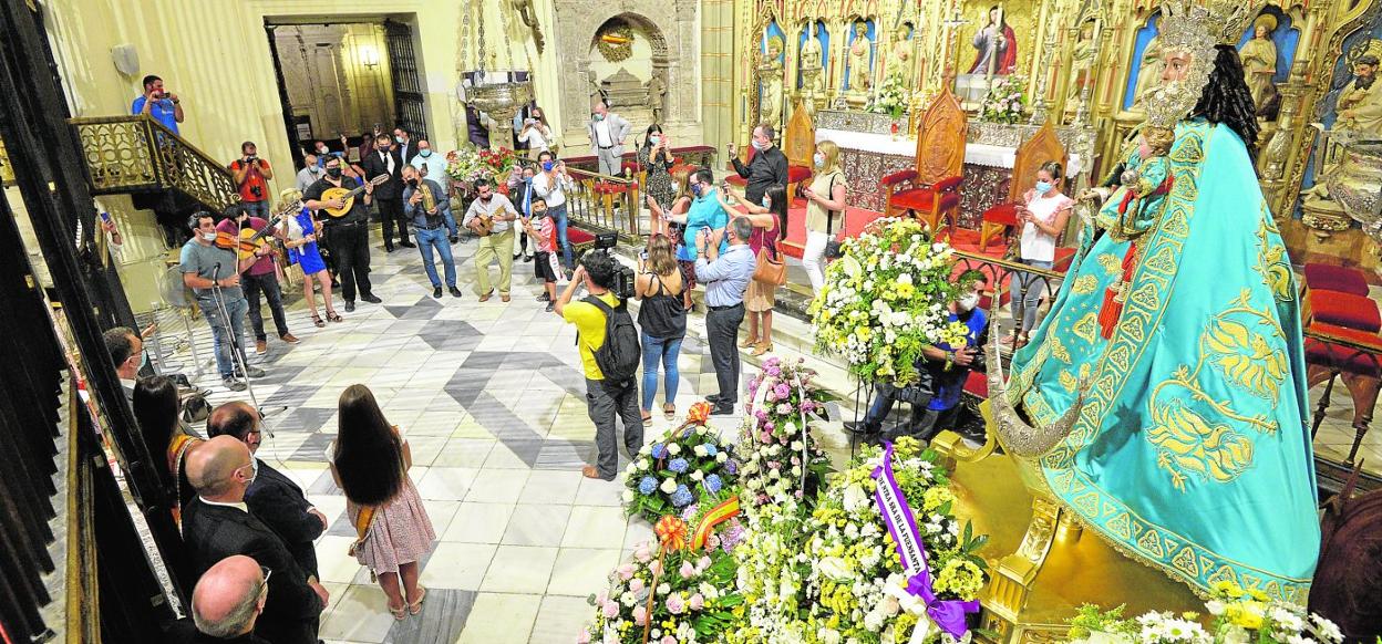 Una cuadrilla de las peñas huertanas honra con sus cánticos a la Virgen de la Fuensanta, sobre un trono cuajado de flores, ayer por la tarde en la Catedral. 