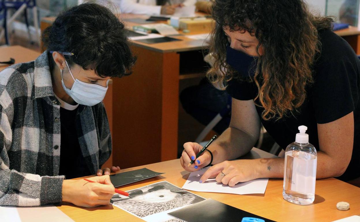 La bióloga e ilustradora científica Clara Cerviño ayuda a uno de los alumnos, el pasado lunes, en el primer día de la novena edición del curso 'Ilustrando la Ciencia'.