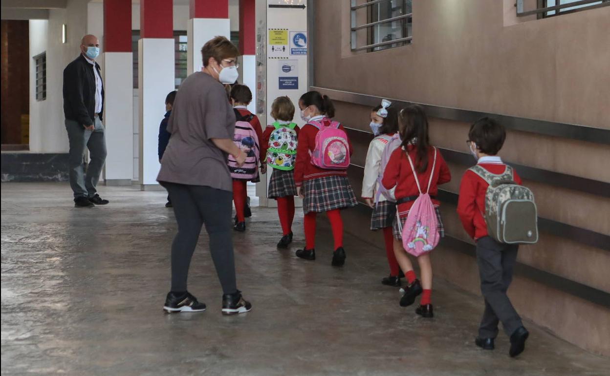 Niños entran a un colegio en Totana. 