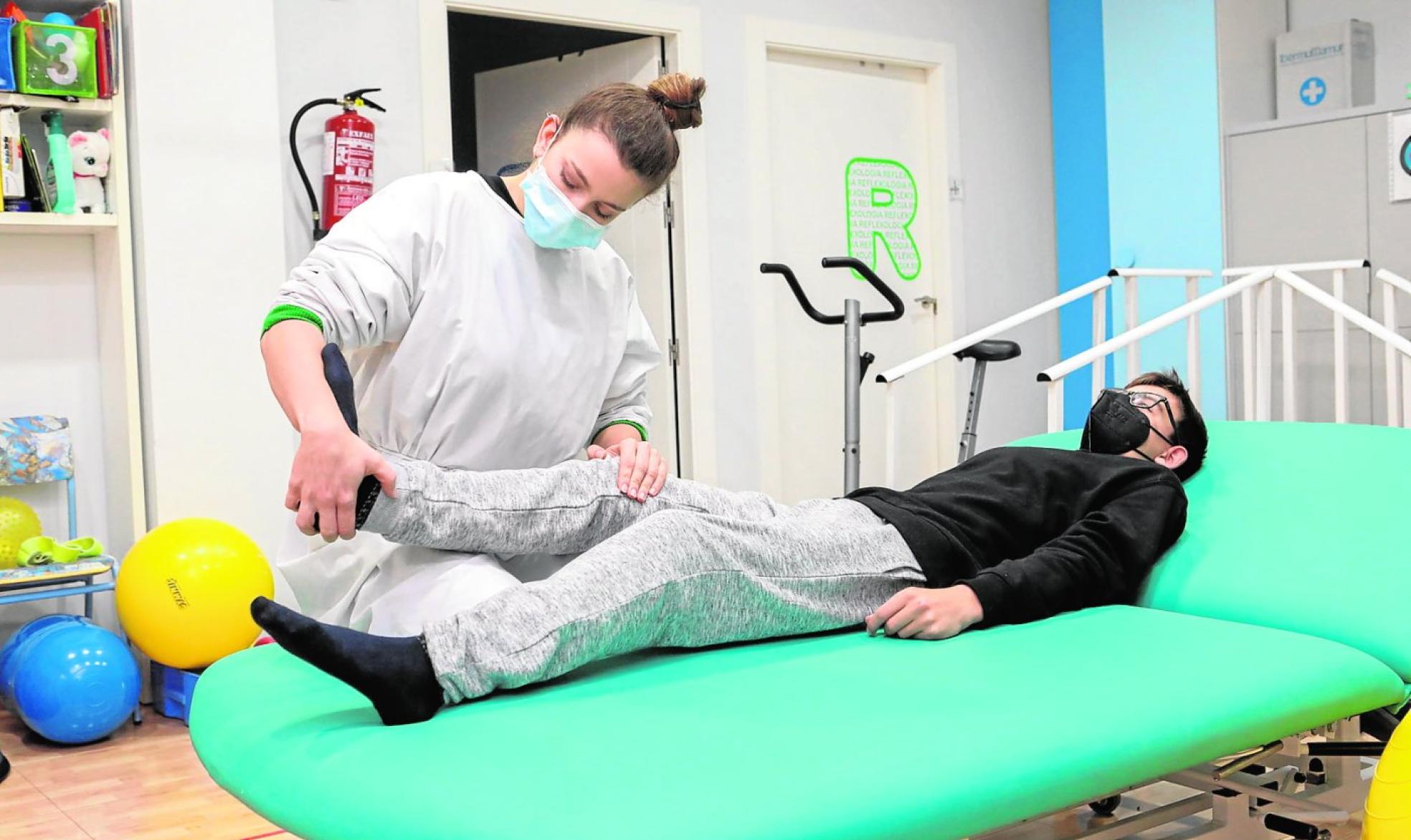 Una profesional de D'genes realiza una sesión de fisioterapia con un usuario en sus instalaciones de Totana. 