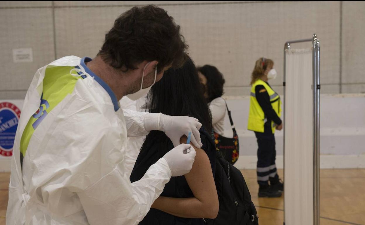Un sanitario vacuna a una docente en el pabellón de Cabezo Beaza, en Cartagena.