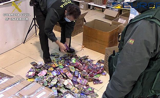 Dos agentes de la Guardia Civil inspeccionan los juguetes de un establecimiento.