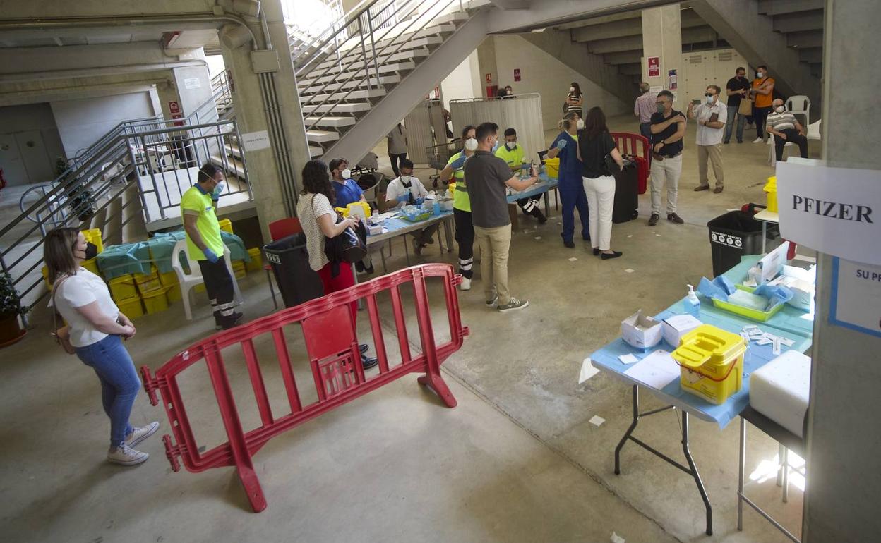 Cola para recibir la vacuna de AstraZeneca, ayer, en el estadio Enrique Roca de Murcia, mientras la fila de Pfizer permanece vacía.