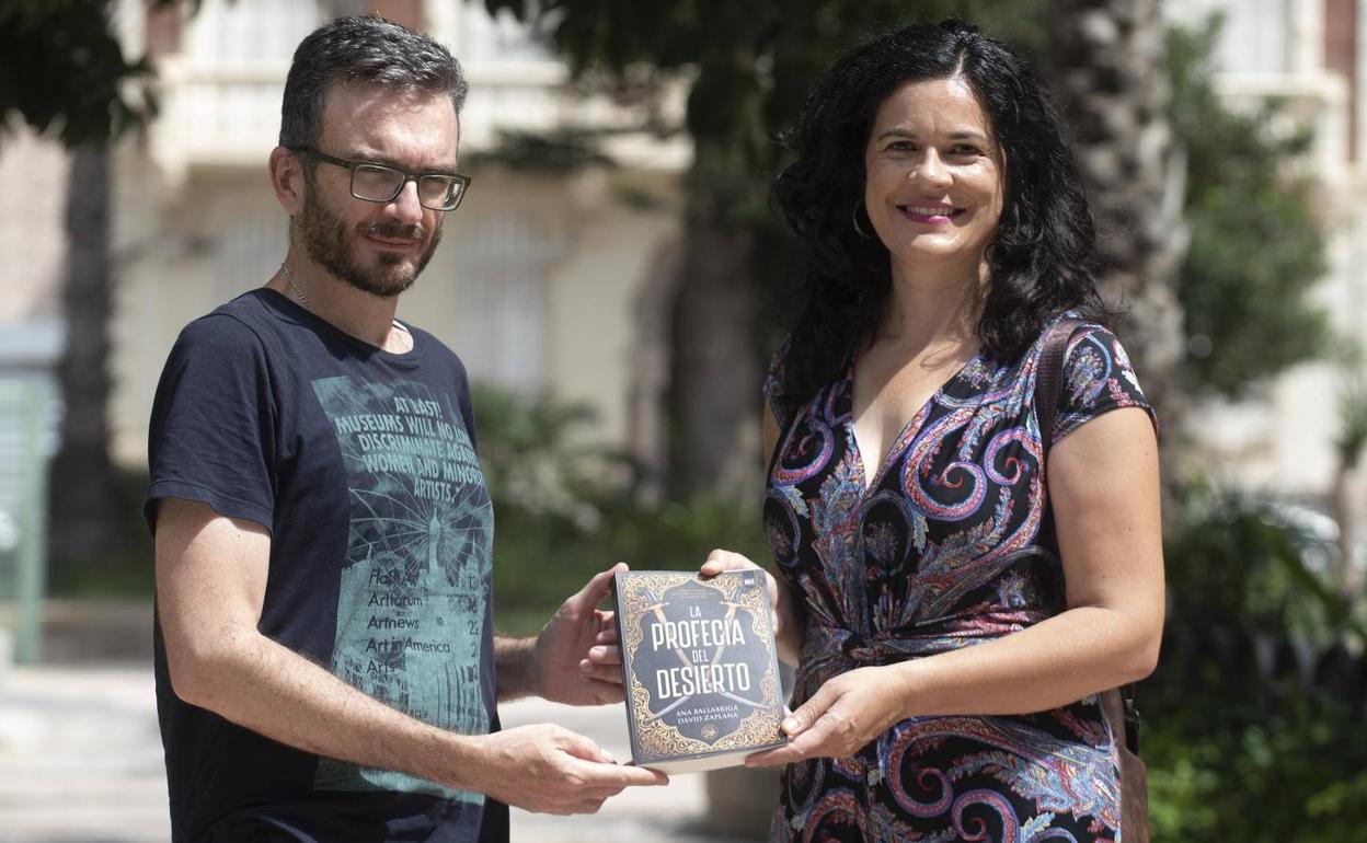 David Zaplana y Ana Ballabriga sostienen entre sus manos un ejemplar de su último libro, 'La profecía del desierto'. 