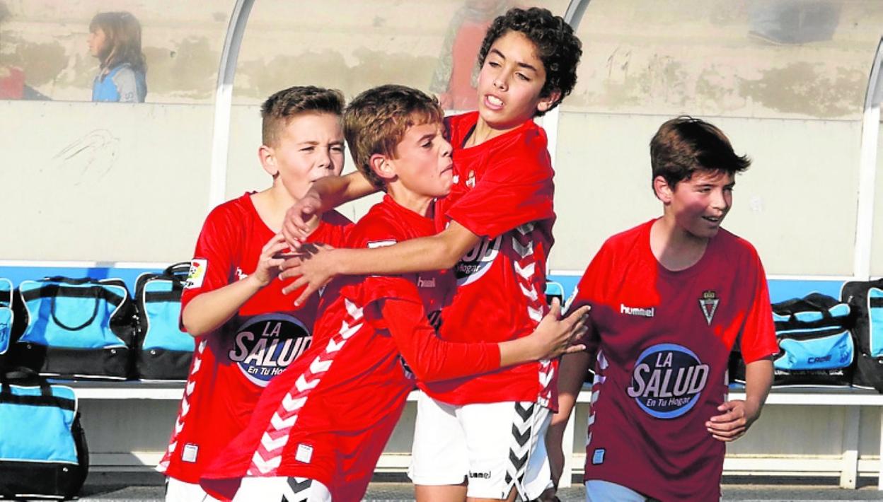 Jugadores de las bases celebran un gol en un Torneo de Navidad. 