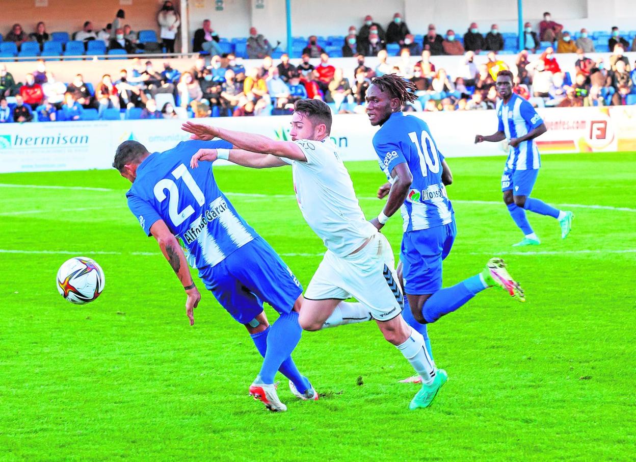 Gaffoor, autor del gol que dio ayer la victoria al Águilas, frena al visitante Valdivia, observado por el local Junior. 