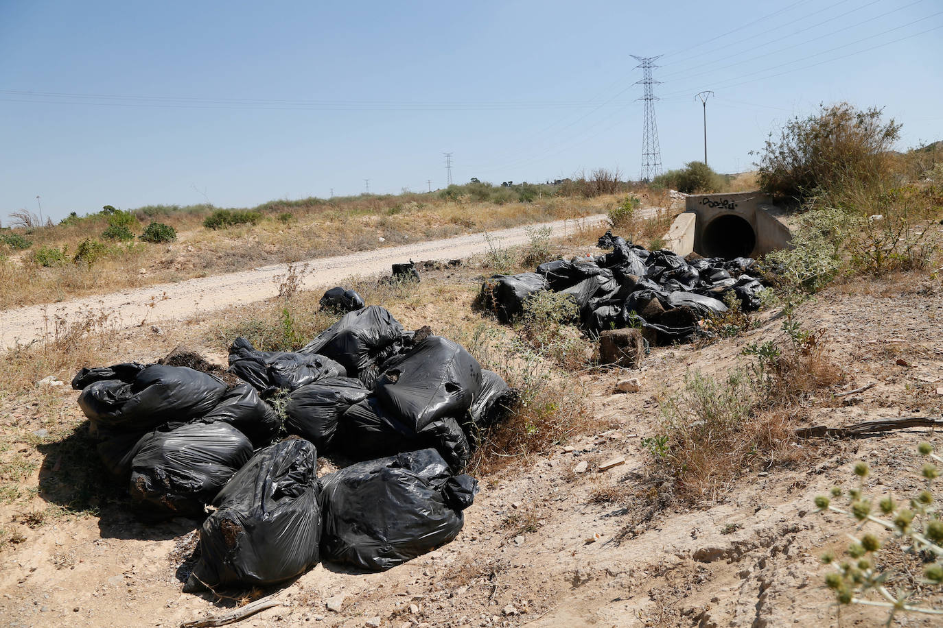 Bolsas llenas de residuos en la cuneta de un vial de servicio de la zona de La Asomada, en la que está proyectado el Ensanche Norte.
