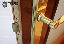 Imagen de la puerta forzada por la Policía para poder acceder a la vivienda.