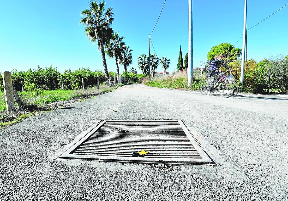 Rejilla de acceso a un tramo de acequia entubado a su paso por la pedanía de Aljucer, sobre el que discurre un vial.