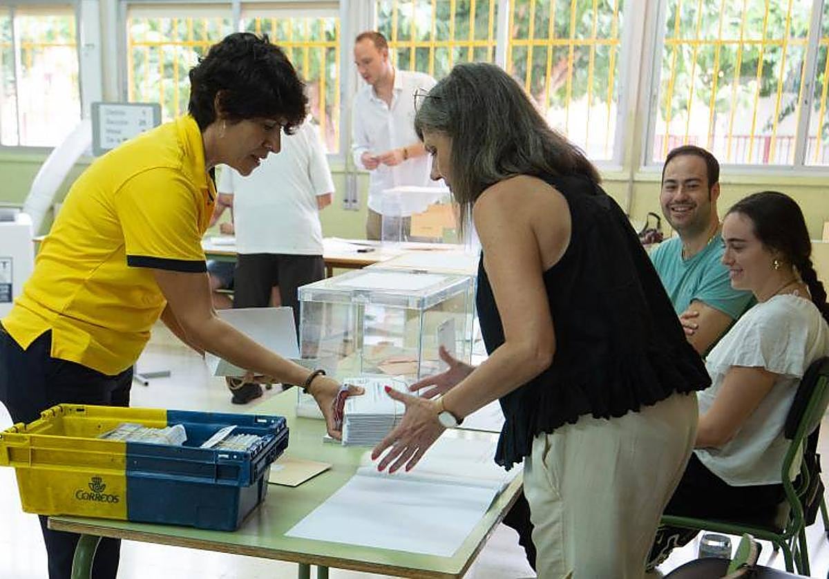Una trabajadora de correos lleva votos por correo a una mesa electoral de Murcia.