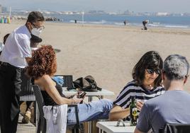 Clientes en la terraza de un bar junto a la playa, en una imagen de archivo.