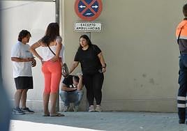 Una persona del entorno de las víctimas del incendio, abatida por la tragedia, recibe muestras de consuelo en el Palacio de Deportes de Murcia.