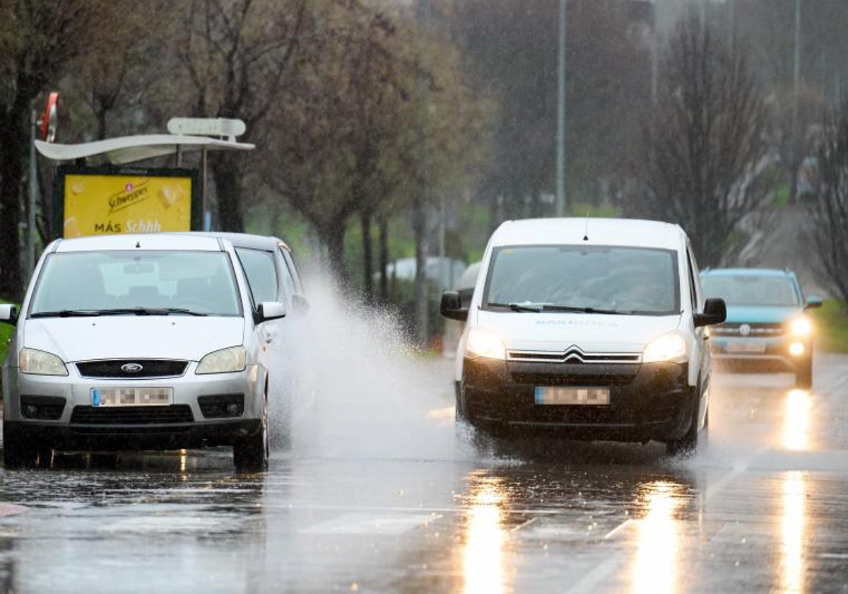 Dos coches conduciendo bajo la lluvia