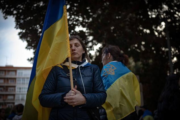 Una mujer ucraniana sostiene una bandera y cierra los ojos mientras escucha el himno de su país en la primera manifestación convocada en Cartagena contra la invasión rusa de Ucrania. 