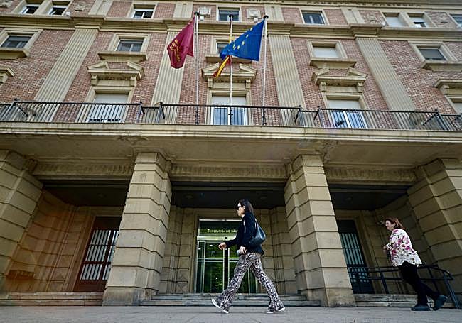 Dos mujeres pasan frente a la Consejería de Hacienda, en Murcia.