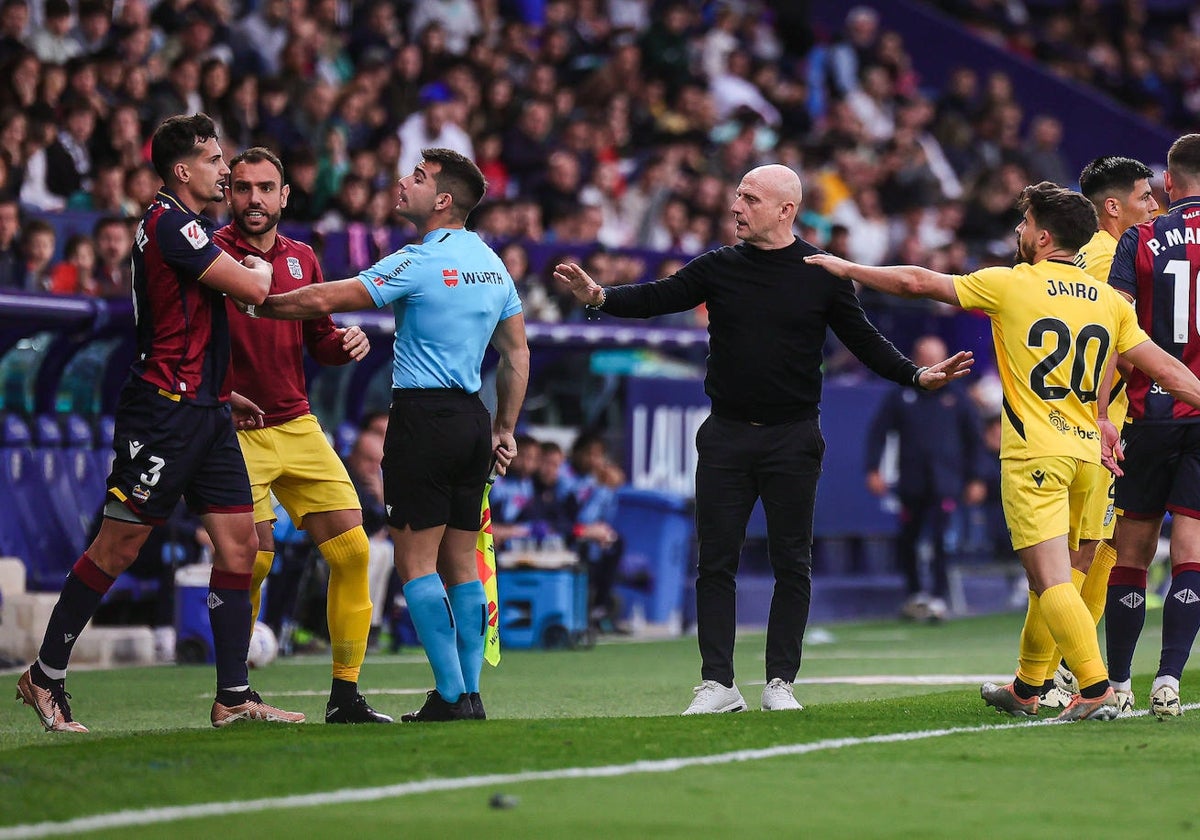 Julián Calero pone paz entre los jugadores del Cartagena, el línea y el local Álex Muñoz, este domingo, en el Ciudad de Valencia.