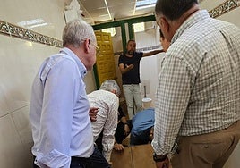 Los concejales y el alcalde inspeccionan los efectos del derrame de combustible.