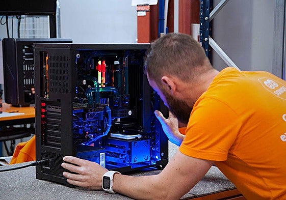 Un trabajador de PcComponentes revisando una torre de ordenador.
