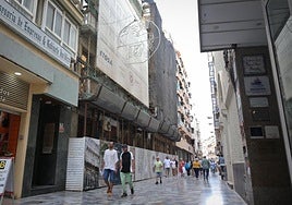 Vista frontal de la Casa Llagostera, en plena calle Mayor de Cartagena, por la que pasean varios grupos de vecinos y turistas.