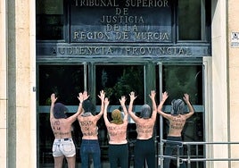 Activistas realizando la 'performance' a las puertas del Palacio de Justicia de Murcia.
