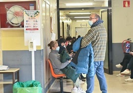 Pacientes en un centro de salud durante una epidemia de gripe, protegidos por mascarillas.