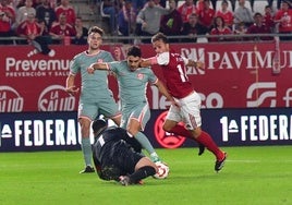 Pedro León, del Real Murcia, persigue un balón ante la salida de Iturbe, del Atlético B.