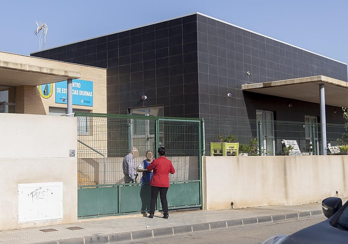 Una mujer visita a usuarios del centro de día de Los Dolores.