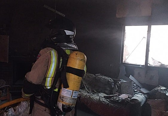 Un bombero en el interior de la vivienda.