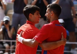 Djokovic habla con Alcaraz tras vencer en la final individual masculina de tenis de los Juegos Olímpicos de París 2024.