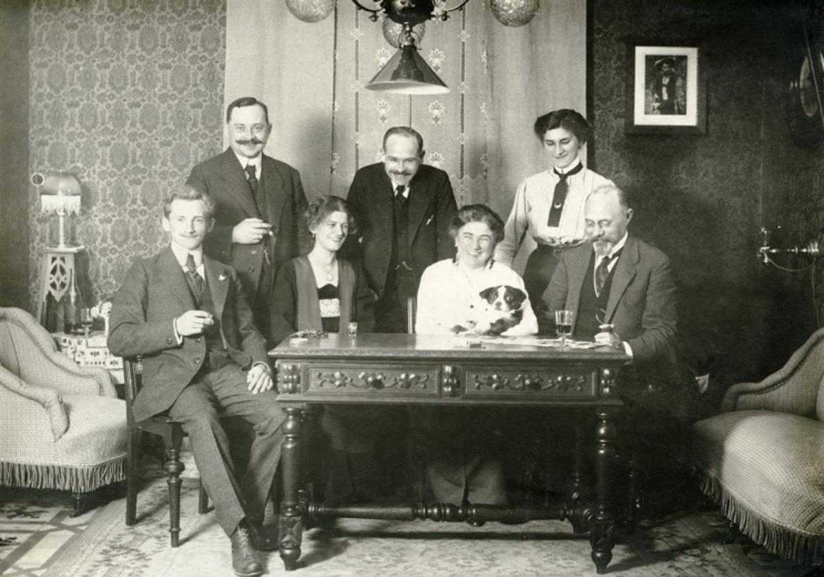 Hans Nonnast (a la izquierda, sentado), en uno de los salones del chalé de la compañía metalúrgica con otros ingenieros y directivos de la empresa y sus esposas, en una de las fotografías del libro. Está fechada en 1915.