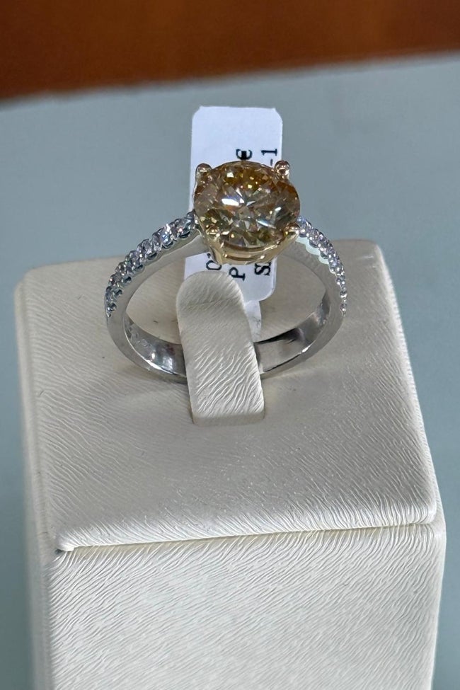 Diamante amarillo con diamantes en el brazo.