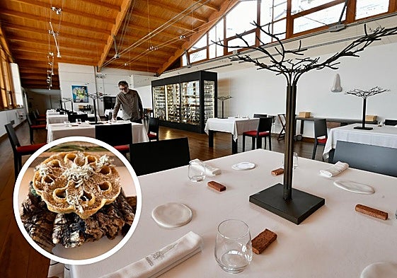 Un camarero prepara las mesas en el restaurante.