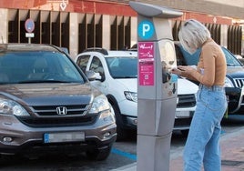 Una usuaria saca un tiquet de un parquímetro en Murcia, en una imagen de archivo.