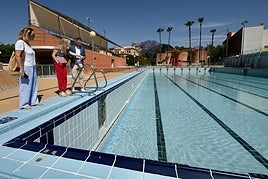 El concejal de Deportes, Miguel Ángel Noguera, junto a dos técnicas del departamento que dirige, este miércoles por la mañana, observando el llenado del vaso de la piscina Murcia Parque, que abrirá sus puertas al público el próximo 9 de junio.