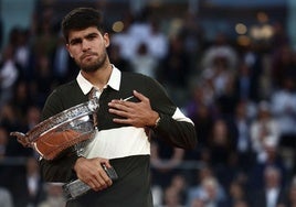 Carlos Alcaraz se lleva la mano al corazón después de recibir la Copa de los Mosqueteros que le corona como ganador de Roland Garros.