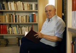 César Oliva posa con uno de los libros que forman parte de la nueva biblioteca de artes escénicas del Teatro Romea.